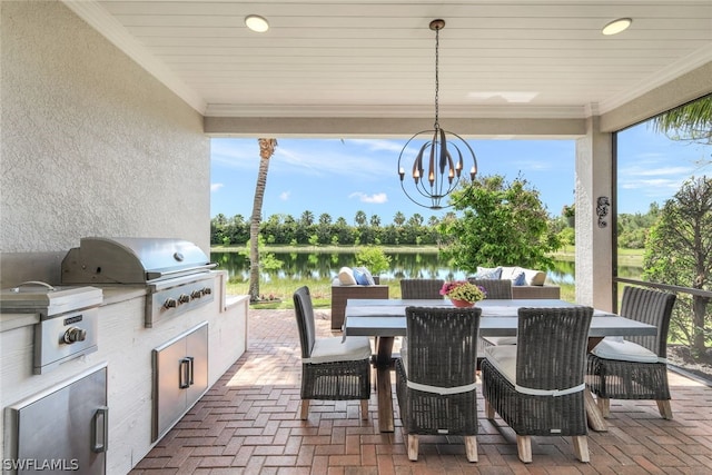 view of patio / terrace with a grill, an outdoor kitchen, and a water view