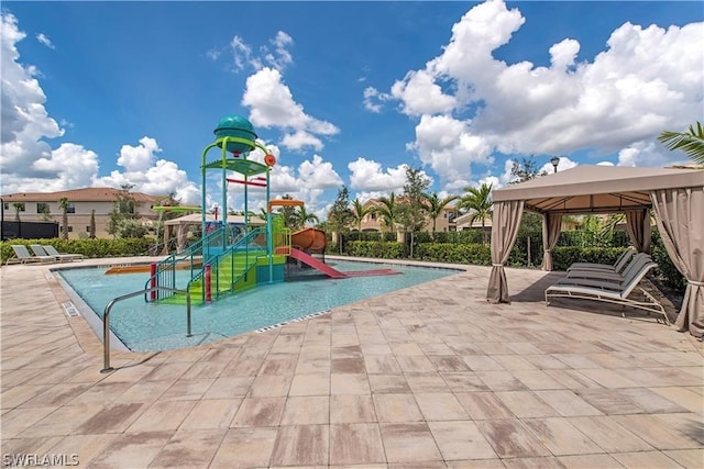 view of play area with a patio, a community pool, and a gazebo