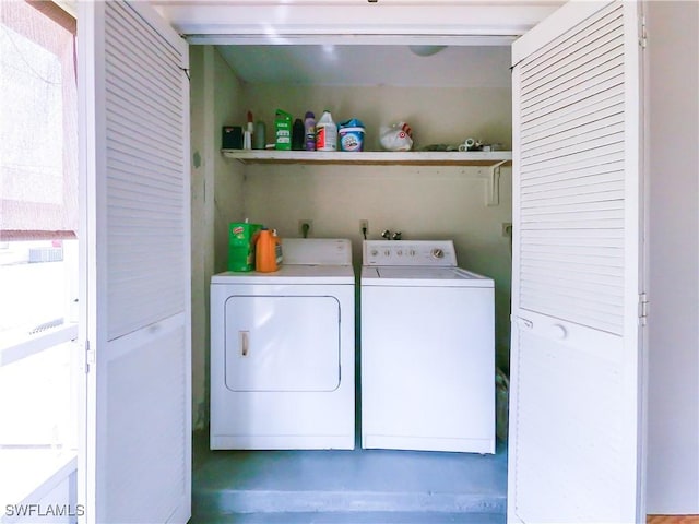 washroom with washing machine and clothes dryer