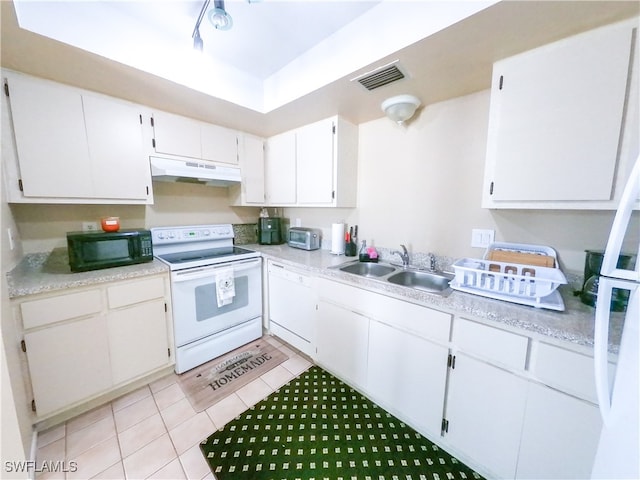 kitchen featuring white cabinetry, white appliances, sink, and light tile patterned floors