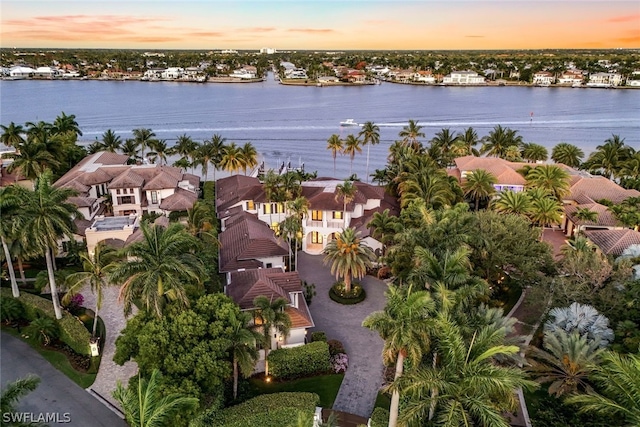 aerial view at dusk with a water view