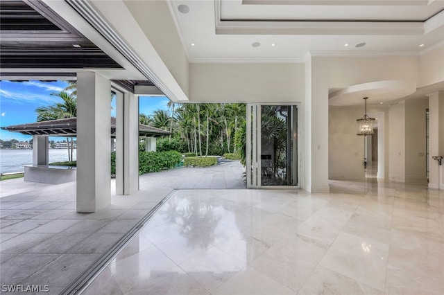 interior space with a healthy amount of sunlight, ornamental molding, and light tile floors