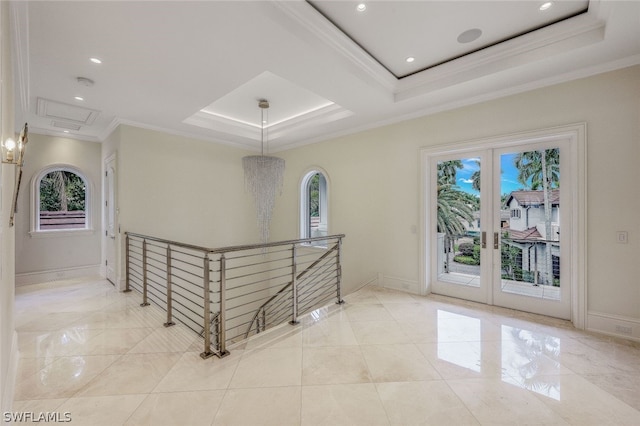 interior space with a tray ceiling, crown molding, and light tile floors