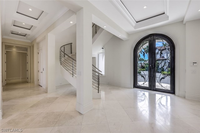 tiled entrance foyer with coffered ceiling, beam ceiling, and french doors