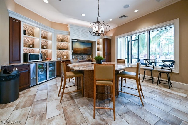 dining space featuring crown molding, light tile flooring, wine cooler, and an inviting chandelier