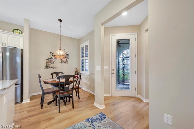 dining space featuring light wood-type flooring