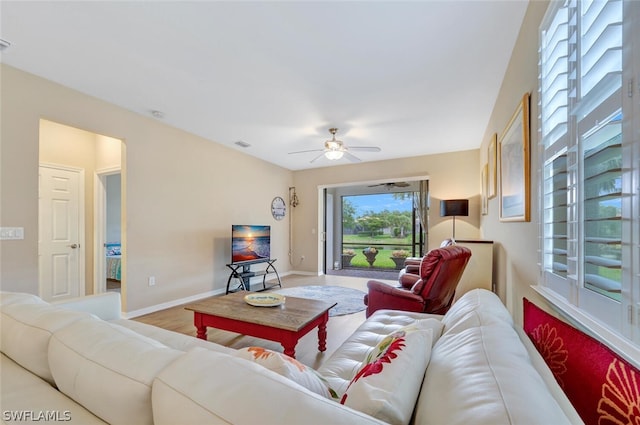 living room featuring ceiling fan and hardwood / wood-style floors