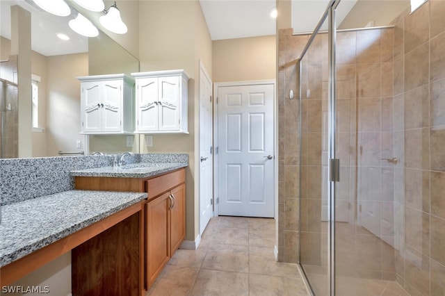 bathroom with an enclosed shower, tile flooring, vanity, and an inviting chandelier