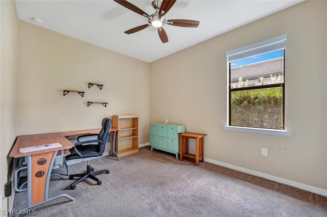 carpeted office space with ceiling fan