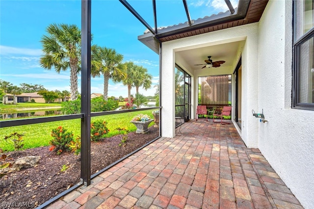 unfurnished sunroom with ceiling fan