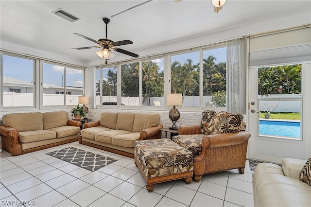 sunroom featuring ceiling fan and plenty of natural light