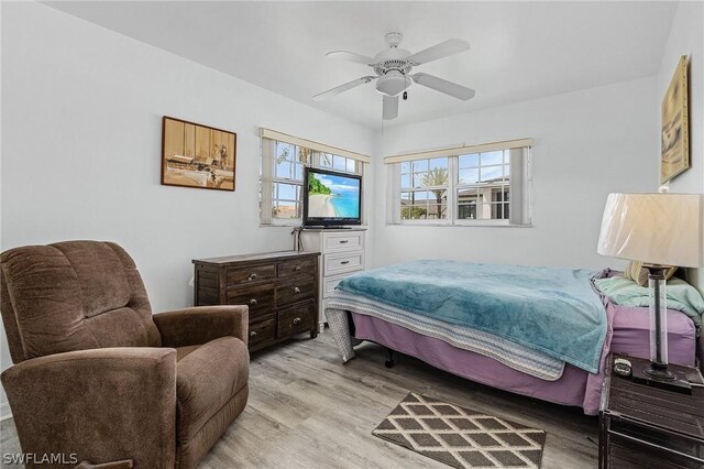 bedroom with ceiling fan and light wood-type flooring