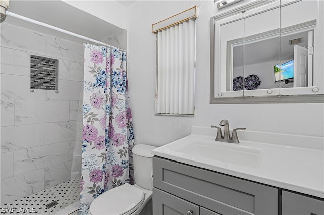 bathroom featuring vanity, walk in shower, and toilet