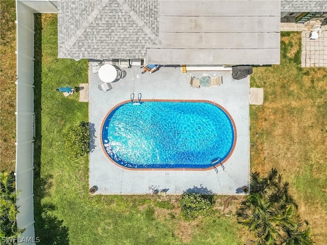 view of pool with a yard