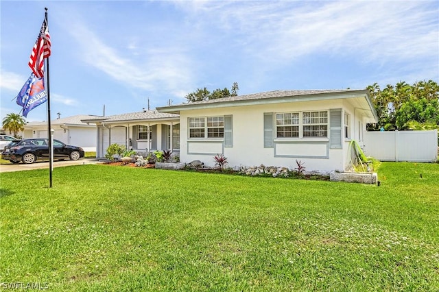 ranch-style home with a front lawn and a garage