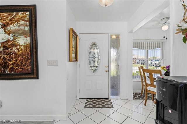 tiled entryway with ceiling fan