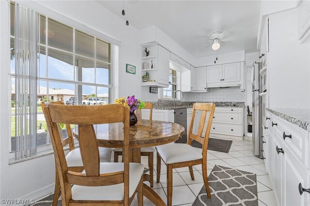 tiled dining area featuring ceiling fan