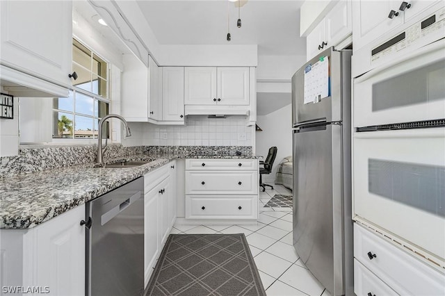 kitchen with white cabinets, appliances with stainless steel finishes, and sink