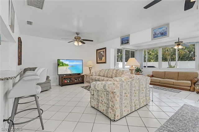 living room featuring light tile patterned flooring and ceiling fan