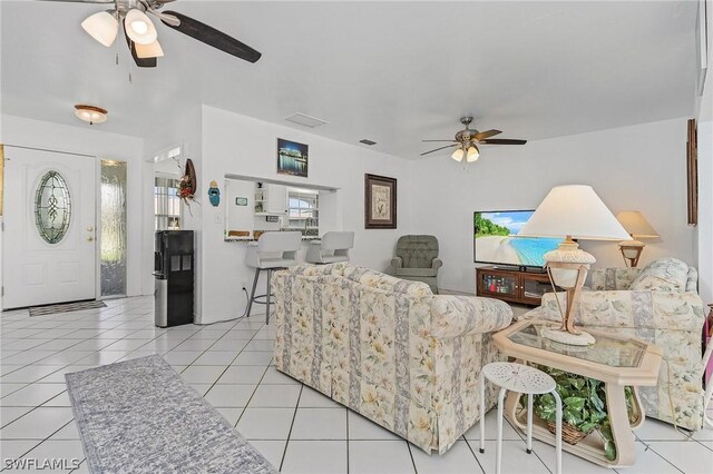 living room featuring light tile patterned floors and ceiling fan