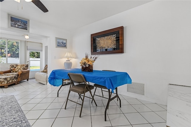 dining room with light tile patterned floors and ceiling fan