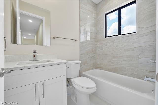 full bathroom featuring tiled shower / bath, vanity, and toilet