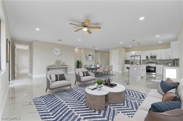 living room with ceiling fan and sink