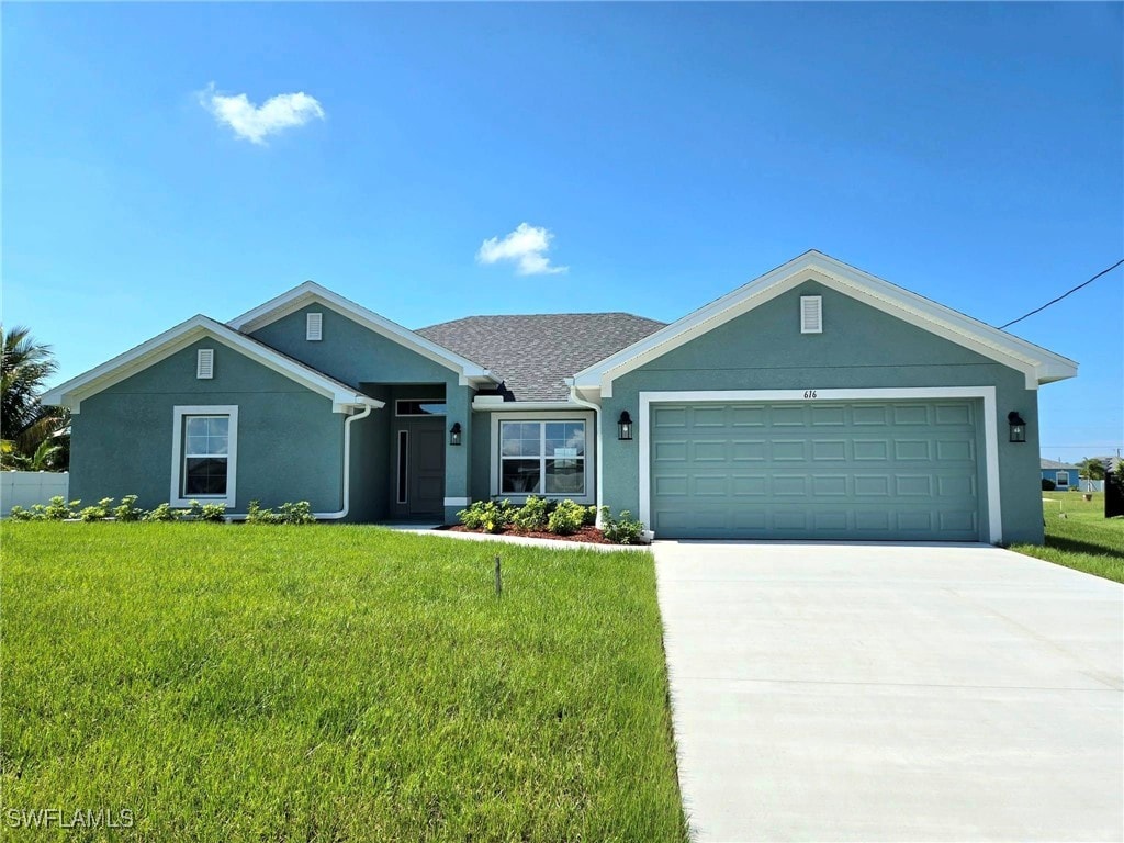 ranch-style house with a front yard and a garage