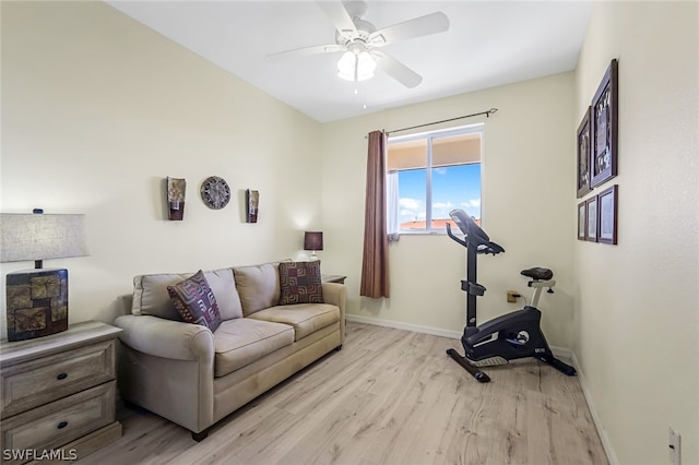 exercise area with ceiling fan and light hardwood / wood-style flooring