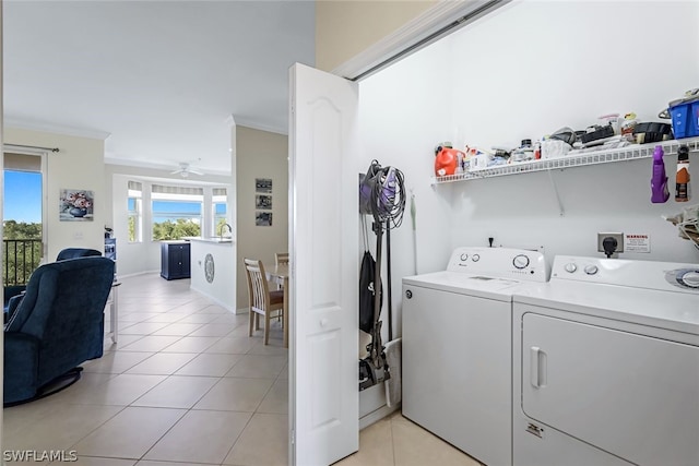 laundry room with ceiling fan, washer and clothes dryer, ornamental molding, and light tile patterned flooring