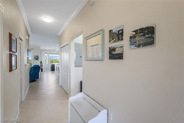 hall featuring crown molding and light tile patterned floors