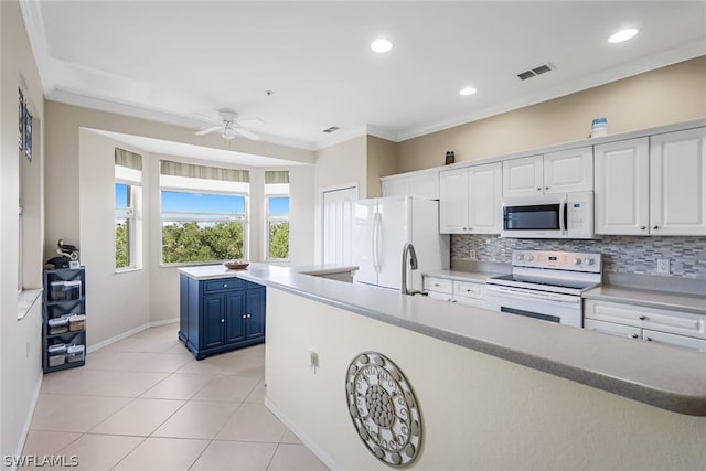 kitchen with white appliances, white cabinets, backsplash, ceiling fan, and blue cabinets