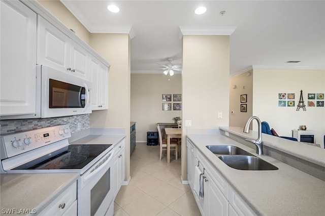 kitchen with sink, white cabinets, tasteful backsplash, light tile patterned floors, and white appliances