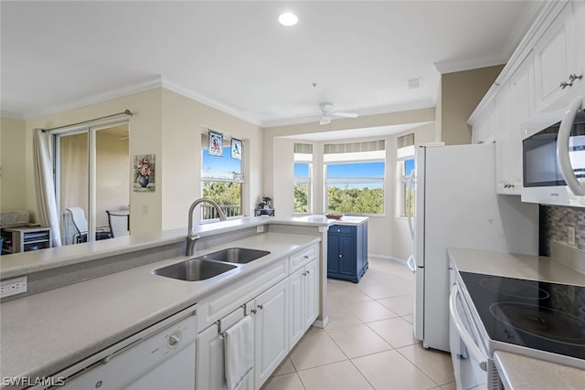 kitchen with white appliances, white cabinetry, sink, blue cabinetry, and ceiling fan