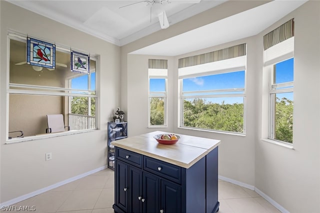 kitchen with a kitchen island, a healthy amount of sunlight, and light tile patterned floors