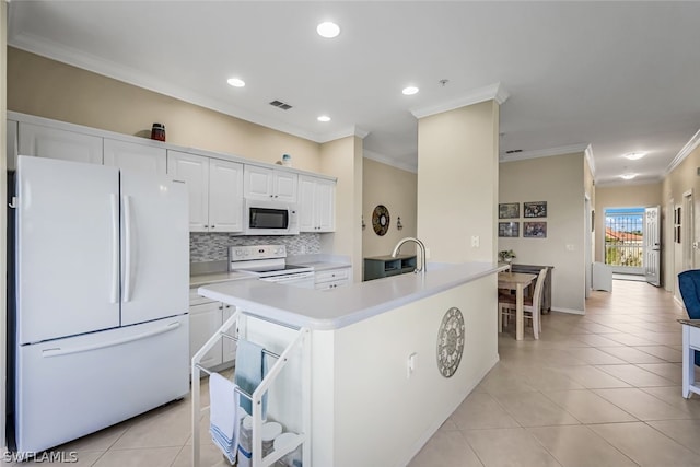 kitchen with light tile patterned flooring, white cabinetry, decorative backsplash, ornamental molding, and white appliances