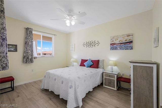 bedroom with light hardwood / wood-style flooring and ceiling fan