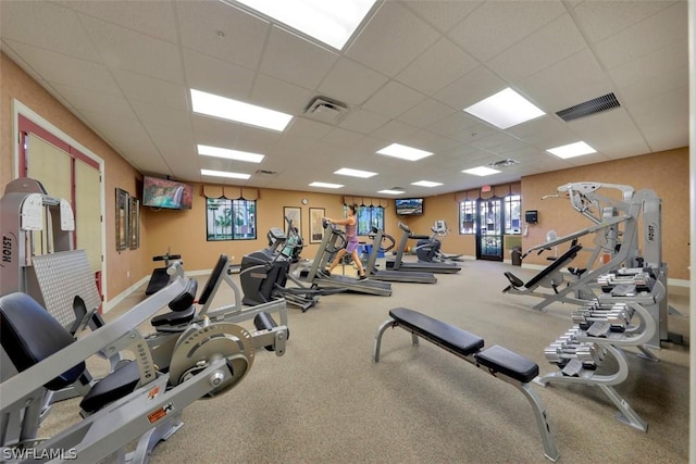 gym with a paneled ceiling