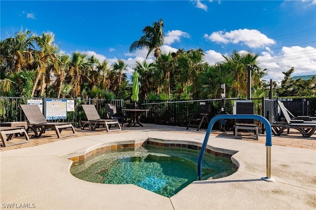 view of swimming pool featuring a patio and a hot tub