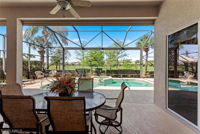 view of patio featuring a swimming pool with hot tub, a lanai, and ceiling fan