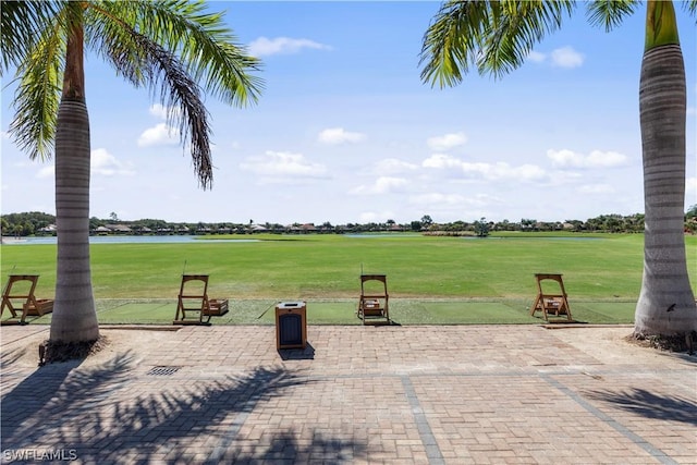 view of patio / terrace with a water view and golf course view