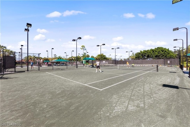 view of tennis court featuring fence