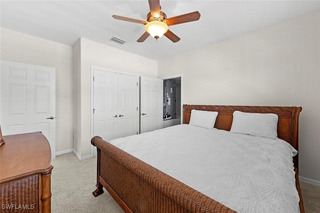 bedroom with baseboards, visible vents, and light colored carpet