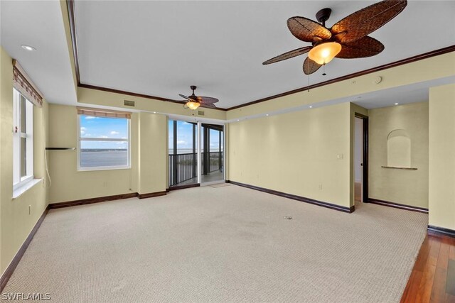 spare room featuring light hardwood / wood-style floors, ornamental molding, and ceiling fan