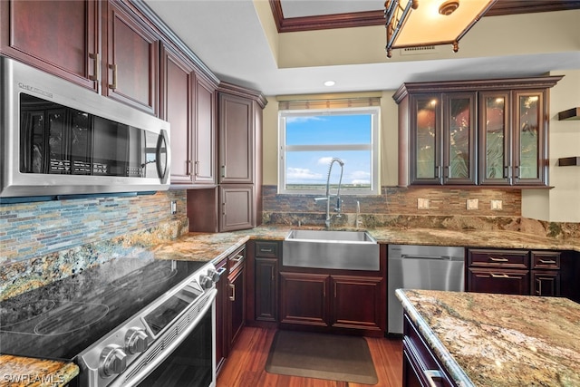 kitchen featuring dark hardwood / wood-style floors, tasteful backsplash, dishwashing machine, range, and sink