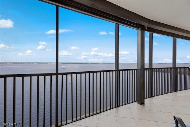 unfurnished sunroom featuring a water view