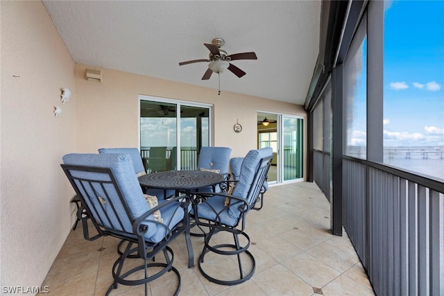 sunroom featuring ceiling fan