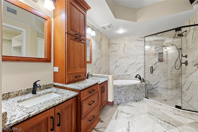 bathroom featuring tile patterned flooring, separate shower and tub, and vanity