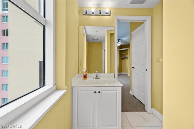bathroom featuring vanity, a ceiling fan, tile patterned flooring, visible vents, and baseboards