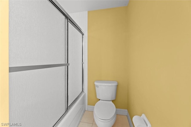 full bathroom with toilet, enclosed tub / shower combo, baseboards, and tile patterned flooring